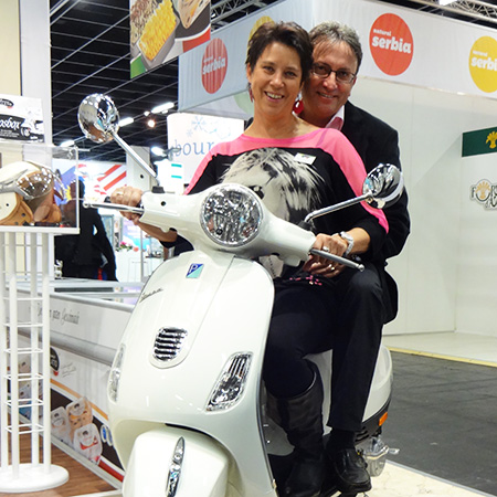 Bruno Gelato, Heidi and Bruno Lucchetta sitting on a Vespa